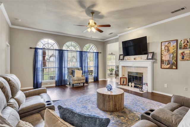 living room with a wealth of natural light, dark hardwood / wood-style floors, and ornamental molding