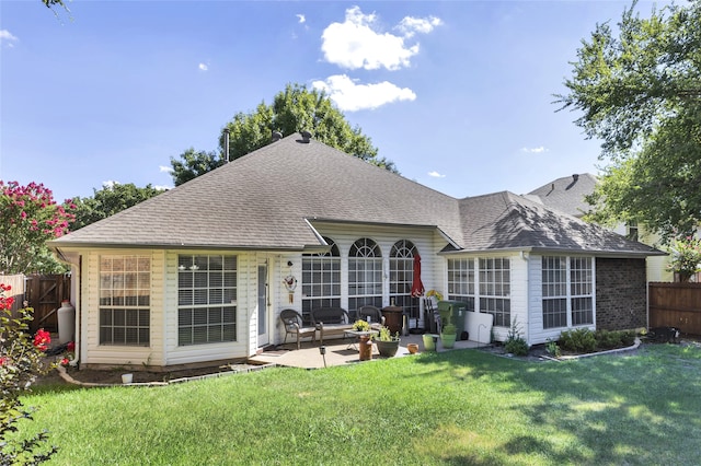 back of property with a patio and a yard