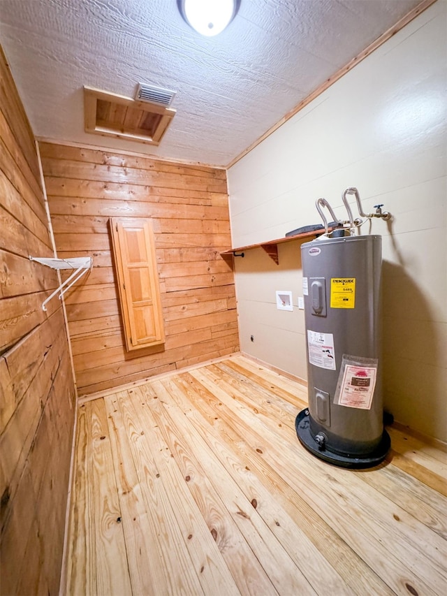 utility room with electric water heater