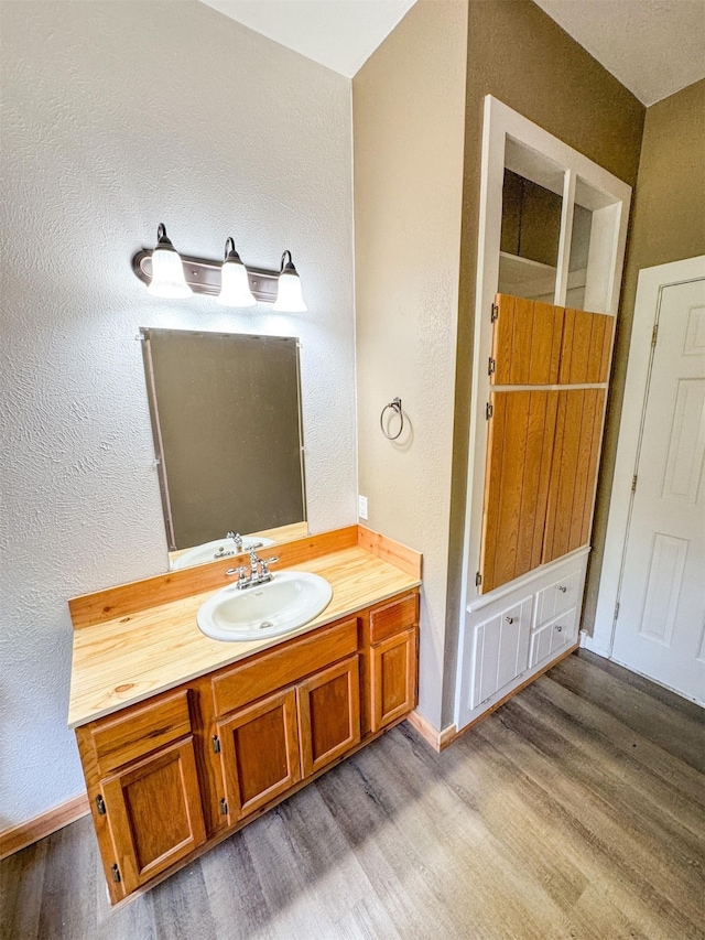 bathroom with wood-type flooring and vanity