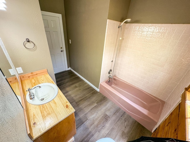 bathroom featuring shower / bath combination, vanity, and wood-type flooring