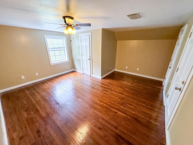 unfurnished bedroom with hardwood / wood-style flooring, lofted ceiling, and ceiling fan