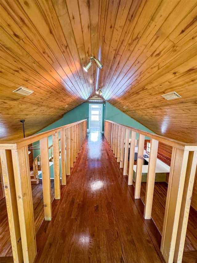 corridor with hardwood / wood-style flooring, vaulted ceiling, and wooden ceiling