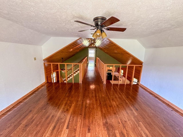 bonus room featuring wood-type flooring, vaulted ceiling, and ceiling fan