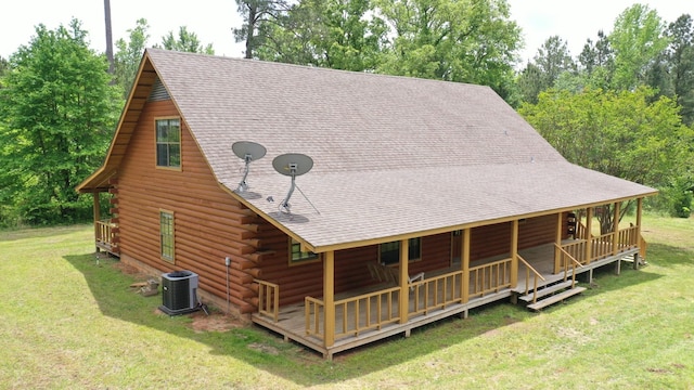 back of house featuring central AC and a lawn