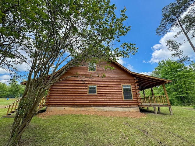 view of side of home with a yard