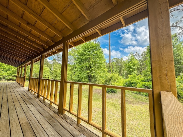 wooden deck with a lawn