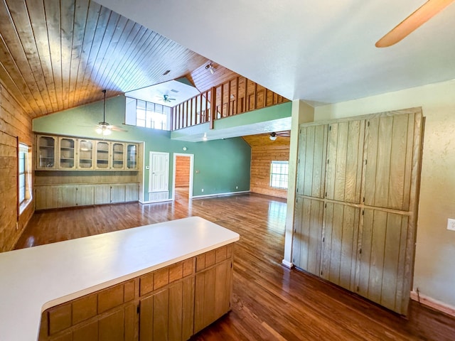 kitchen with wooden ceiling, dark hardwood / wood-style flooring, wooden walls, and ceiling fan