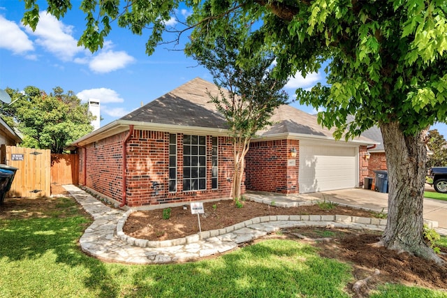 ranch-style home featuring a garage and a front yard