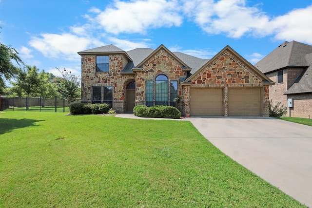 view of front facade featuring a garage and a front yard