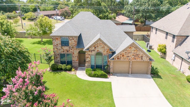 view of front of house with a garage and a front lawn