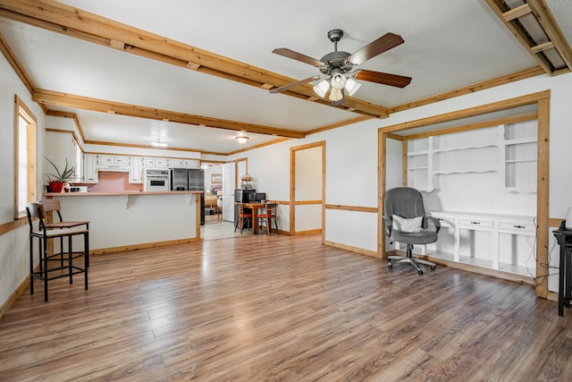 dining space with crown molding and ceiling fan