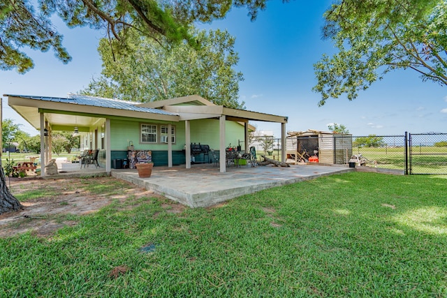 rear view of house featuring a lawn, ceiling fan, and a patio