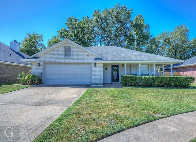 ranch-style home with a garage and a front lawn