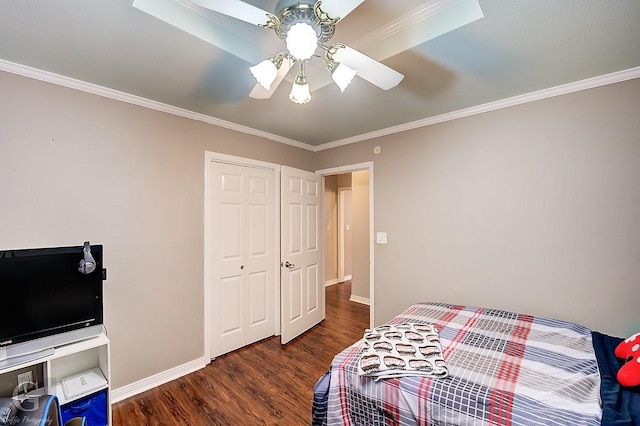 bedroom with crown molding, dark hardwood / wood-style floors, and a closet