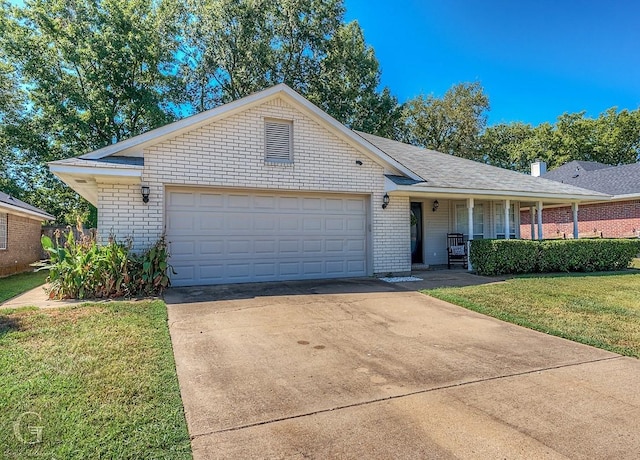 ranch-style house featuring a garage, a front lawn, and covered porch