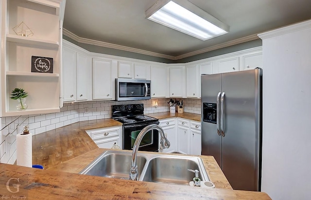 kitchen with stainless steel appliances, white cabinetry, sink, and backsplash