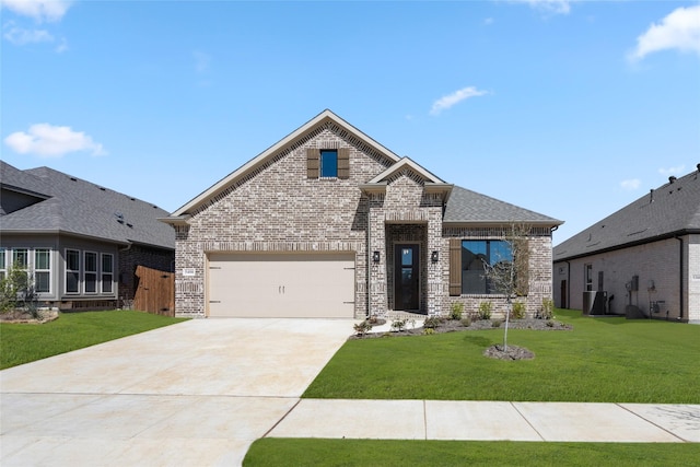 view of front of house featuring a front lawn, roof with shingles, concrete driveway, an attached garage, and brick siding