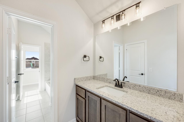 bathroom featuring tile patterned flooring, vanity, and vaulted ceiling