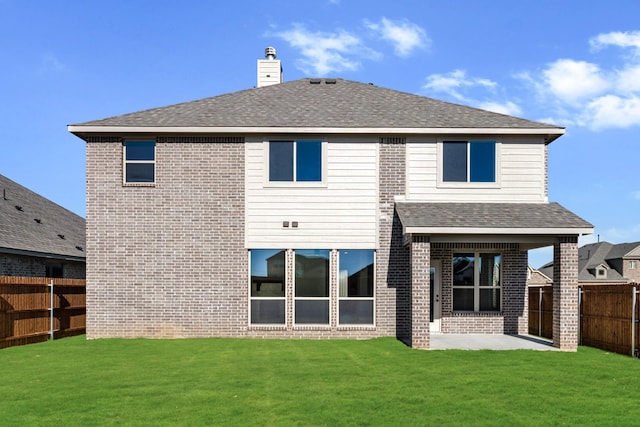 back of property featuring a yard and a patio