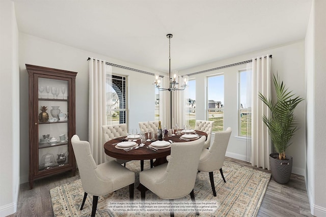 dining room featuring wood-type flooring and a notable chandelier