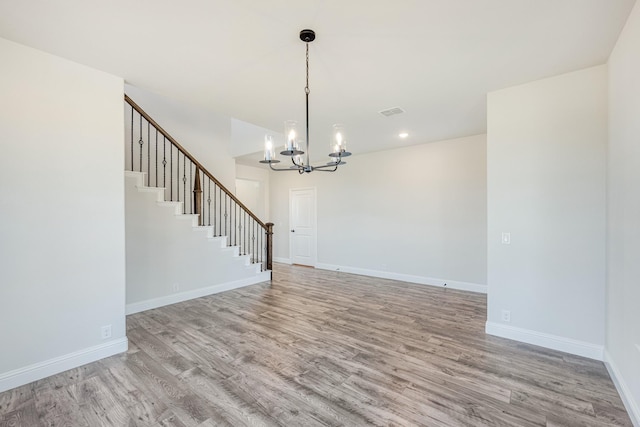 interior space with a chandelier and light hardwood / wood-style floors