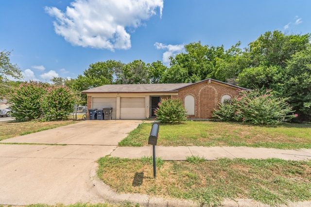 ranch-style house featuring a garage and a front lawn