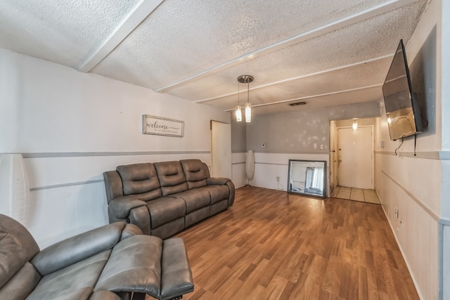 living room with a textured ceiling and tile patterned floors