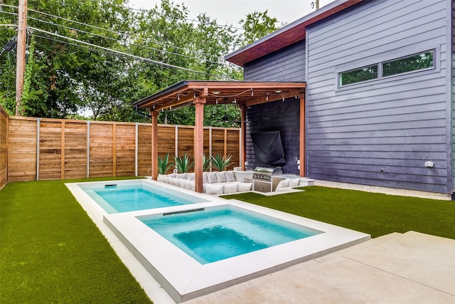 view of pool featuring an in ground hot tub, a patio, and a lawn