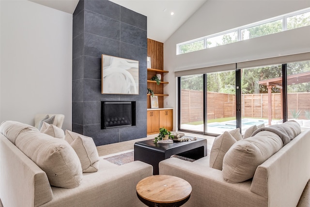 living room with plenty of natural light, tile walls, and a tile fireplace