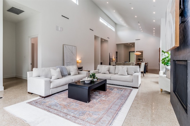 living room with high vaulted ceiling