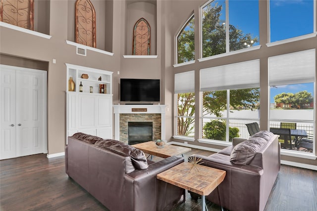 living room featuring a towering ceiling and plenty of natural light