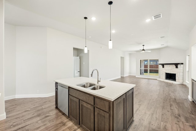 kitchen with dishwasher, sink, ceiling fan, and light hardwood / wood-style floors