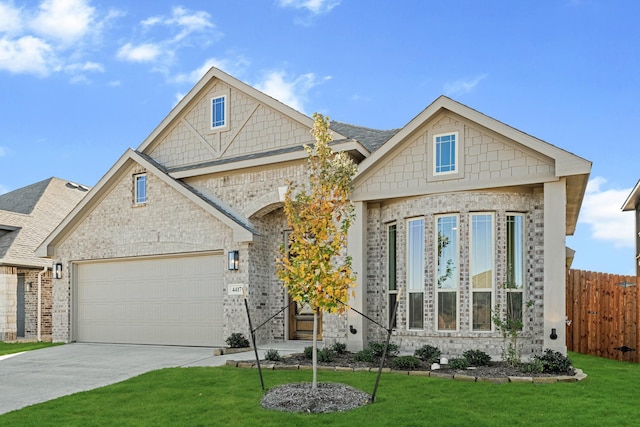 view of front of home with a garage and a front lawn