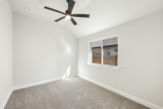 carpeted empty room with vaulted ceiling and ceiling fan