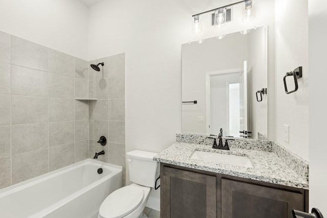 full bathroom featuring tiled shower / bath combo, toilet, and vanity