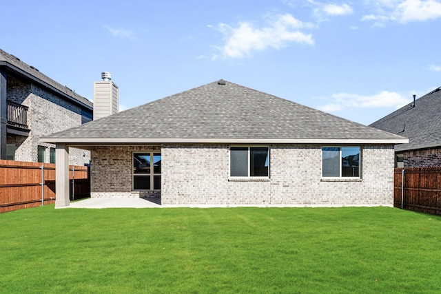 back of property featuring a lawn and a patio