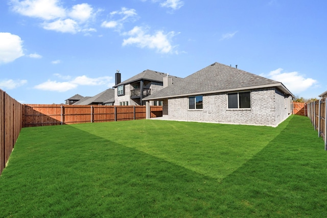 rear view of house featuring a yard