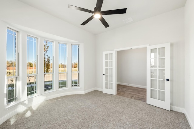 unfurnished room featuring ceiling fan, french doors, and carpet floors