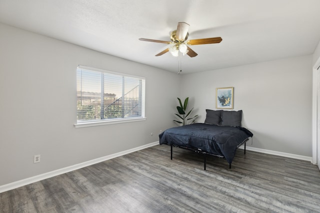 living area with ceiling fan and dark hardwood / wood-style flooring