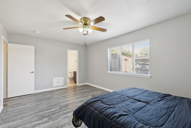 bedroom featuring ceiling fan, hardwood / wood-style floors, and connected bathroom