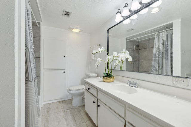 bathroom featuring toilet, a shower with shower curtain, vanity, and a textured ceiling