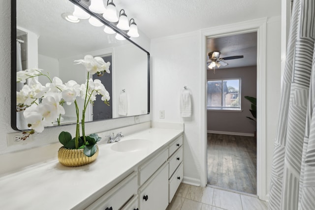 bathroom with vanity, a textured ceiling, and ceiling fan