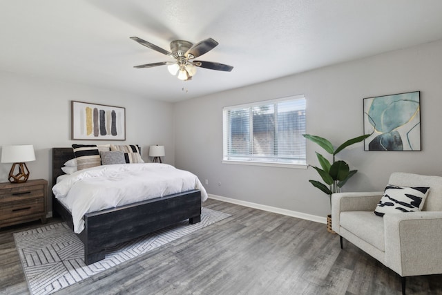 bedroom with ceiling fan and dark hardwood / wood-style flooring