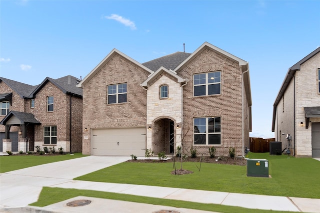 view of front of house with a front yard and a garage