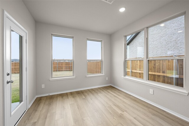 spare room featuring light hardwood / wood-style flooring