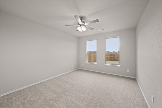 unfurnished room featuring ceiling fan and carpet