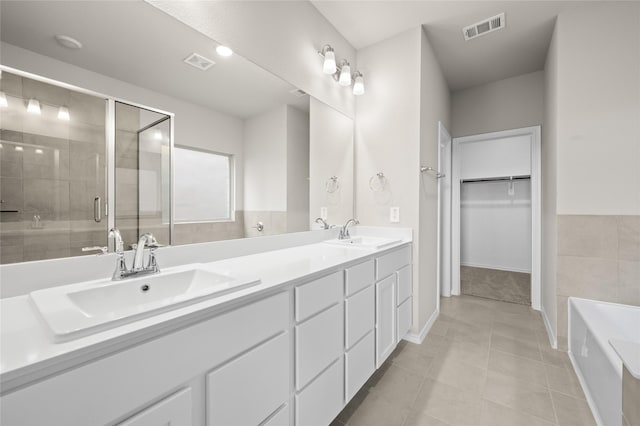 bathroom featuring tile patterned floors, vanity, and separate shower and tub