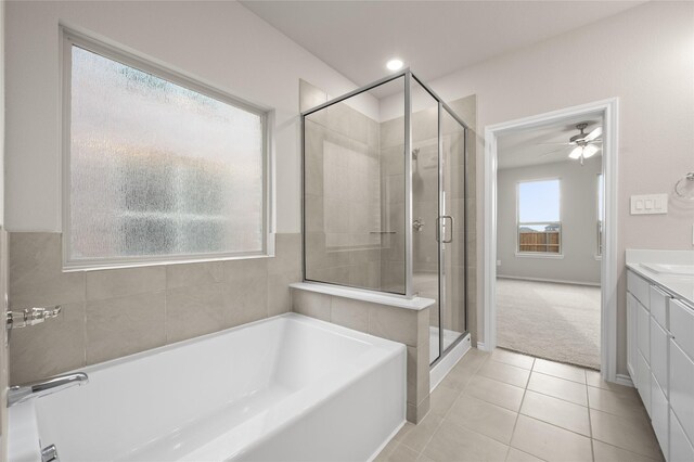 bathroom with independent shower and bath, tile patterned floors, vanity, and ceiling fan