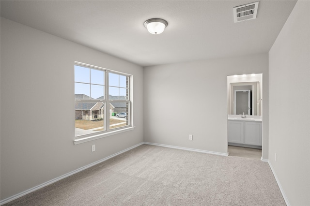 carpeted spare room with sink